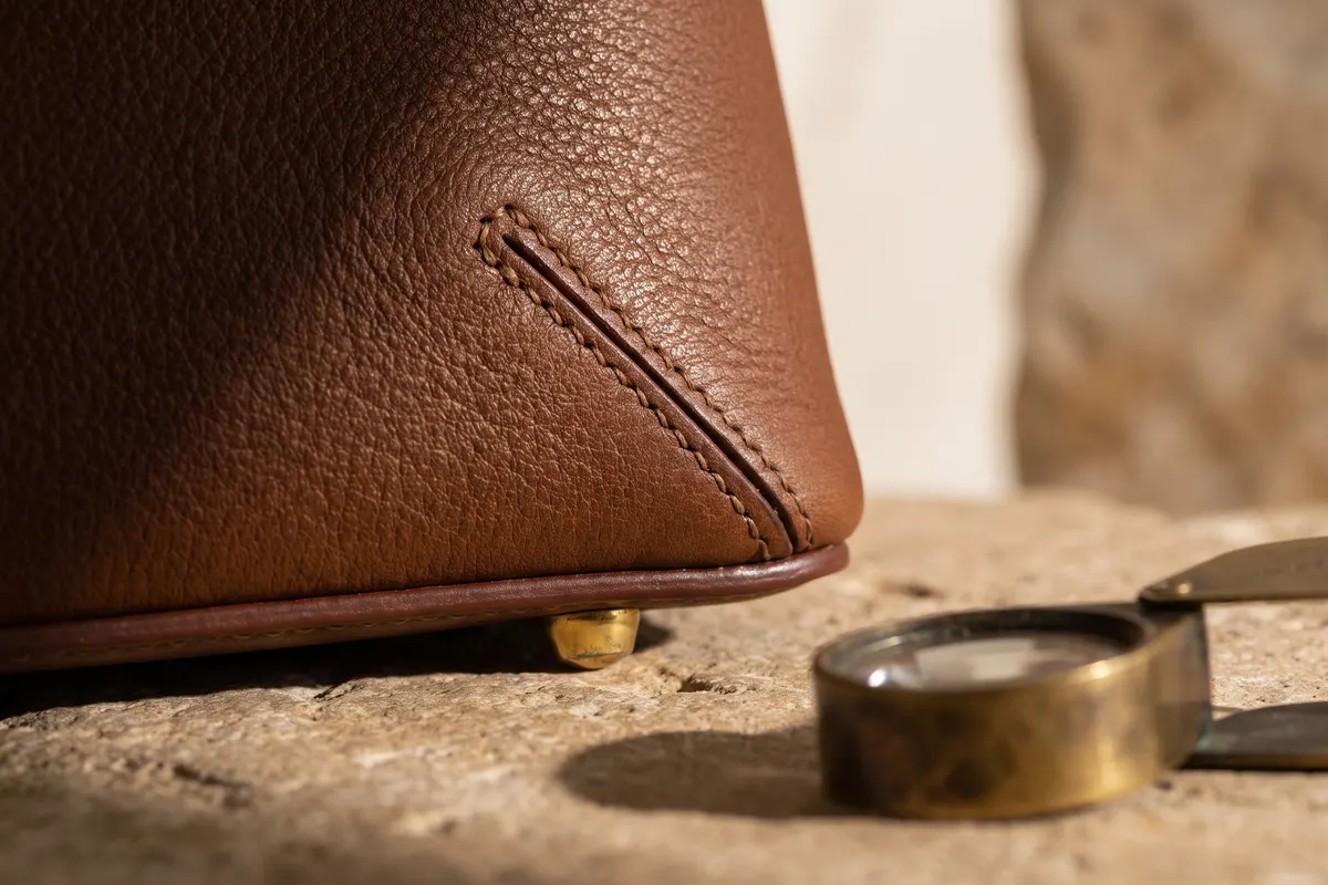 Close-up of hand stitching and edge paint, the first details to check on second hand designer bags