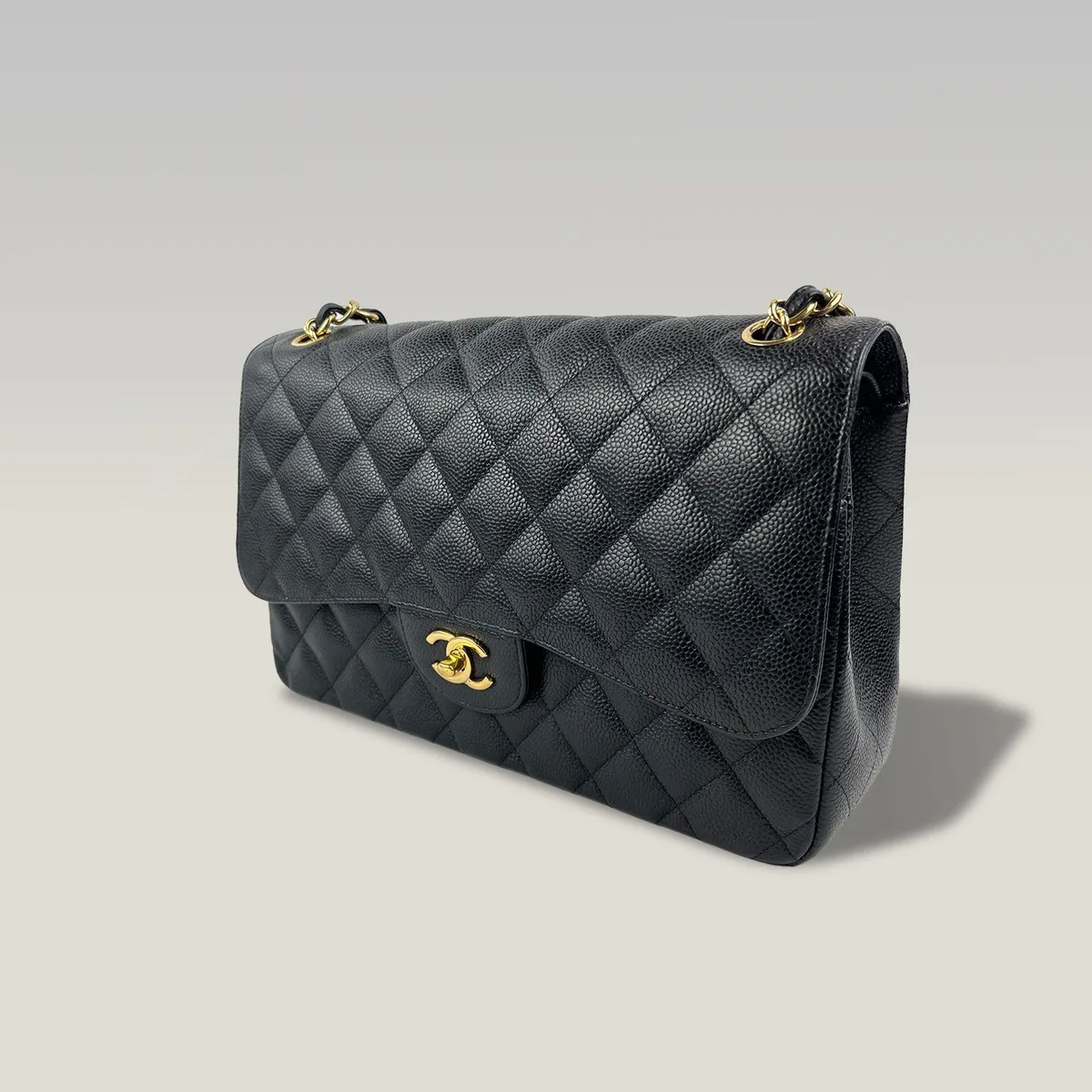 Pre-owned Chanel classic flap bag in Jumbo size, black quilted caviar leather with gold-tone hardware