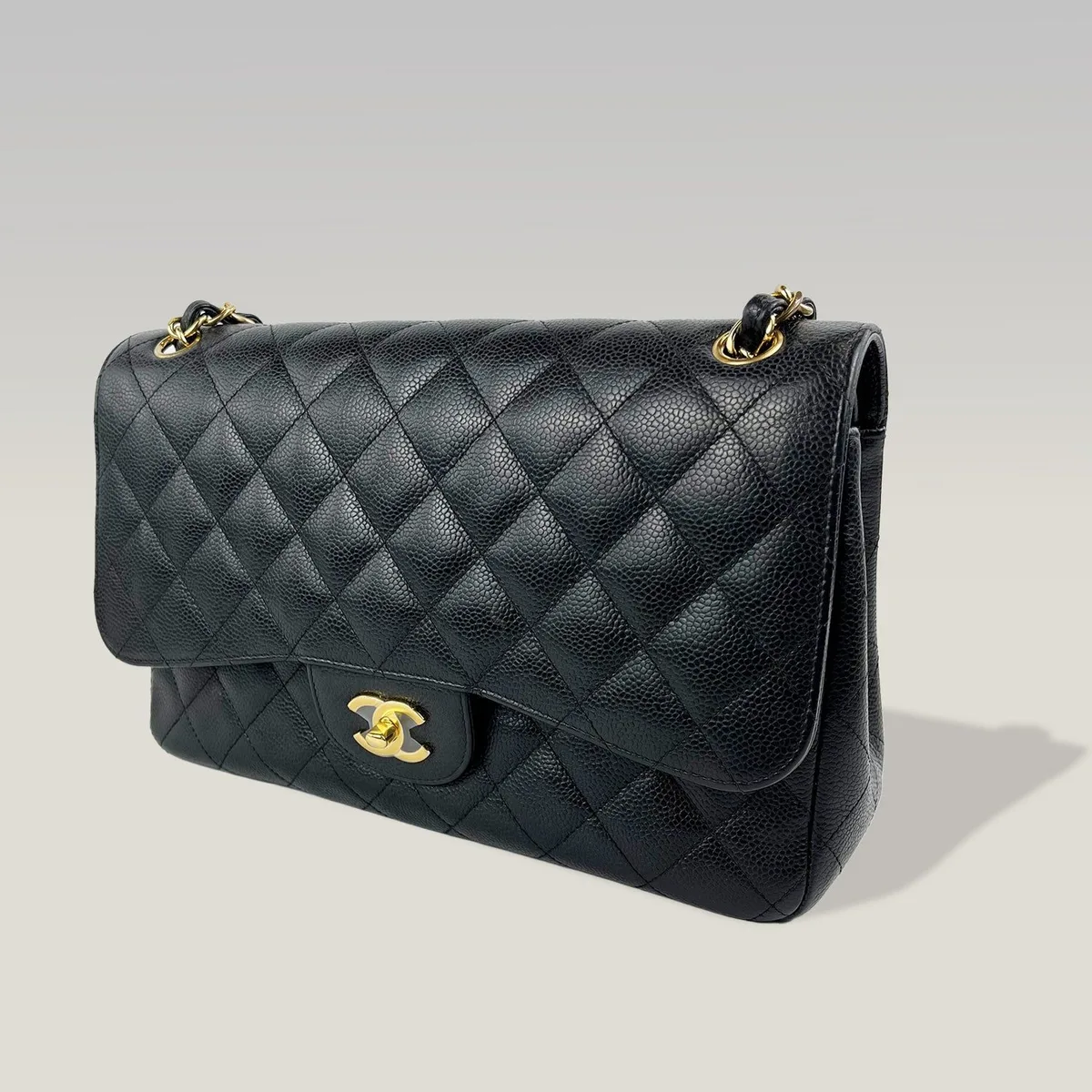 Pre-owned Chanel Classic Flap Jumbo 30 in black lambskin with gold chain, one of the most sought after second hand designer bags