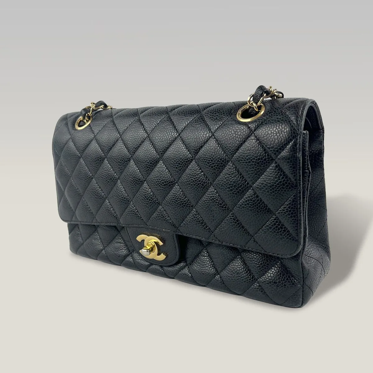 Pre-owned Chanel Classic Medium Double Flap in black caviar leather with gold-tone hardware, ready for a Chanel serial number check
