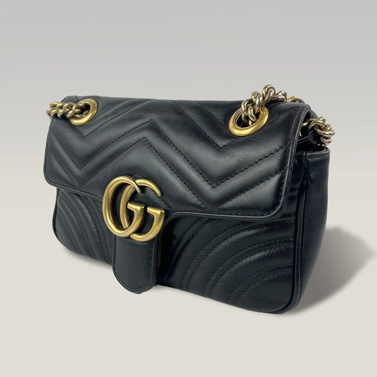 Pre-owned small Gucci Marmont bag in black chevron matelassé leather with gold-tone chain strap