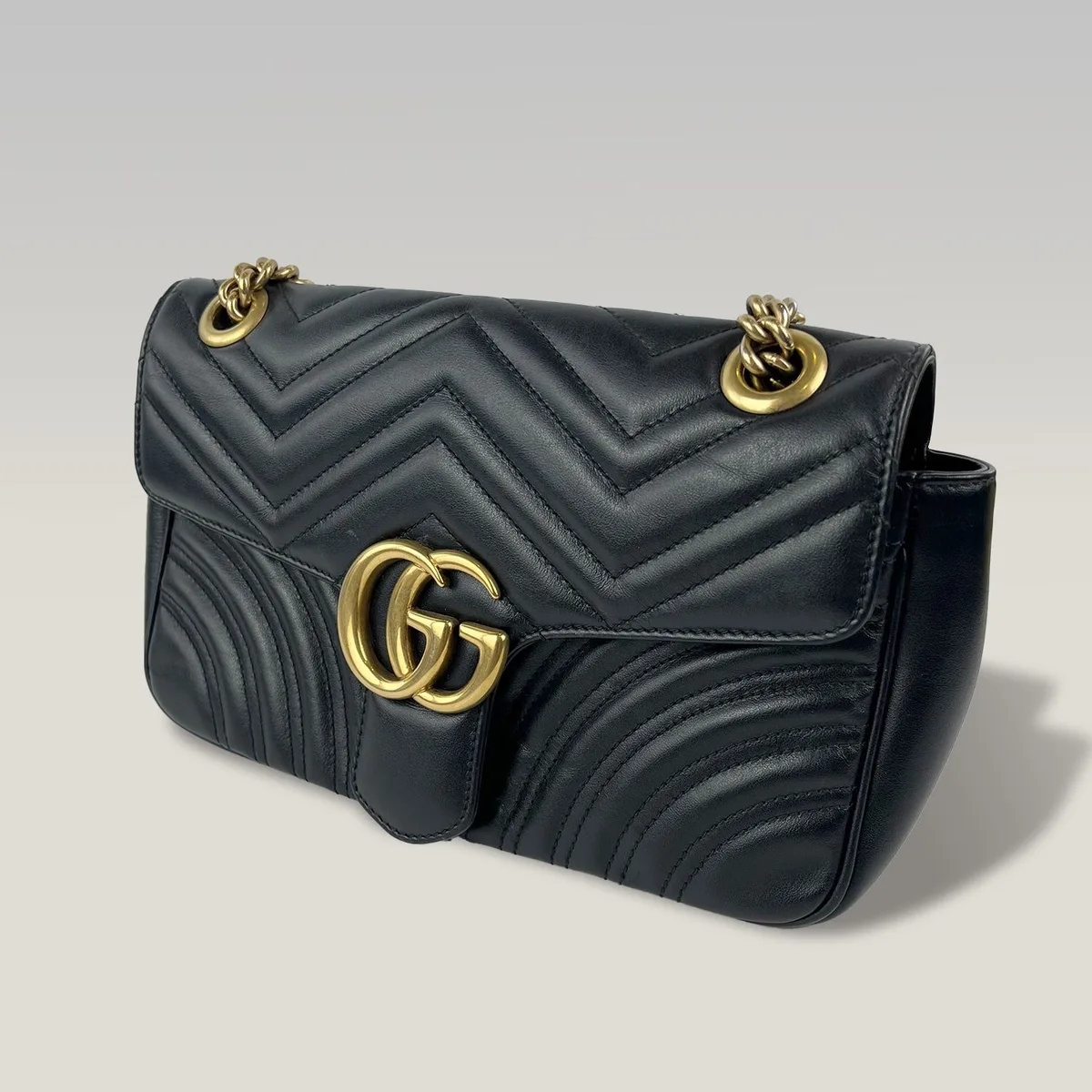 Pre-owned Gucci GG Marmont medium shoulder bag in black matelassé leather with gold-tone chain, ready for a Gucci serial number lookup